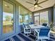 This charming lanai features an outdoor ceiling fan and ample natural light from surrounding windows at 113 Bayou Bend Rd, Groveland, FL 34736