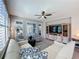 Comfortable living room featuring plantation shutters and modern ceiling fan at 113 Bayou Bend Rd, Groveland, FL 34736