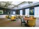 Meeting room with multiple tables, comfortable seating, and modern wall decor at 113 Bayou Bend Rd, Groveland, FL 34736
