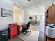 Bright office features hardwood floors, a desk, and seamless access to the kitchen and dining area at 113 Bayou Bend Rd, Groveland, FL 34736