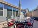Outdoor dining on a brick patio with a glass table and seating for six at 113 Bayou Bend Rd, Groveland, FL 34736