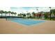 Community tennis court with well-maintained court surface and lush landscaping at 113 Bayou Bend Rd, Groveland, FL 34736