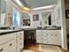 Bright bathroom with double vanities, wood floors, and natural light at 113 Willow Ln, Leesburg, FL 34748