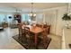 Warm and welcoming dining area with an eight-person dining table and ample seating space at 113 Willow Ln, Leesburg, FL 34748