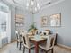 Dining room with a chandelier, art, and a set dining table at 11735 Se 173Rd Lane Rd., Summerfield, FL 34491