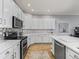 Bright kitchen featuring stainless steel appliances, white cabinets, and light-colored countertops at 11735 Se 173Rd Lane Rd., Summerfield, FL 34491