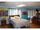 Bedroom with blue walls, a neutral comforter, and coordinating curtains at 1202 Deidrich Ct, Eustis, FL 32726