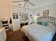 Cozy bedroom featuring a ceiling fan, closet with mirrored doors, and a comfortable bed at 122 Tamarisk Way, Leesburg, FL 34748