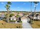 An aerial view of home showcasing front yard, lush landscaping, and community at 12455 Se 92Nd Ter, Summerfield, FL 34491