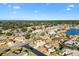 A great aerial view of a property in a tranquil neighborhood surrounded by lush greenery, mature trees, and a nearby lake at 12455 Se 92Nd Ter, Summerfield, FL 34491