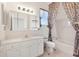 Bright bathroom features a single sink vanity, large mirror and shower-tub combination at 12455 Se 92Nd Ter, Summerfield, FL 34491