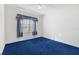 Bedroom with blue carpeting, ceiling fan and a window at 12455 Se 92Nd Ter, Summerfield, FL 34491