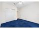 Bedroom with blue carpeting, ceiling fan and large closet at 12455 Se 92Nd Ter, Summerfield, FL 34491