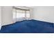 Bedroom with blue carpeting, and a large bay window with curtains at 12455 Se 92Nd Ter, Summerfield, FL 34491