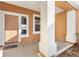 Inviting front porch with neutral tones and a view of the home's entrance, featuring a solid front door at 12455 Se 92Nd Ter, Summerfield, FL 34491