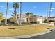 Home featuring manicured lawn, shrubs, and large palm trees at 12455 Se 92Nd Ter, Summerfield, FL 34491