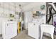 Practical laundry room with washer, dryer, utility sink, and storage shelving at 12455 Se 92Nd Ter, Summerfield, FL 34491