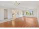 Bright and airy living room boasts laminate flooring, modern lighting, and a seamless transition to the kitchen at 12455 Se 92Nd Ter, Summerfield, FL 34491
