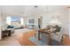 Open-concept living and dining area with hardwood floors, a modern chandelier, and abundant natural light at 12455 Se 92Nd Ter, Summerfield, FL 34491