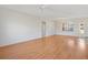 Large living room featuring laminate floors, a ceiling fan, and abundant natural light through windows at 12455 Se 92Nd Ter, Summerfield, FL 34491