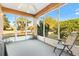 Relaxing screened sunroom with ceiling fan provides natural light and backyard views at 12455 Se 92Nd Ter, Summerfield, FL 34491