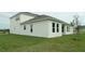 Home's backyard with green lawn and exterior view of the house at 14365 Crest Palm Ave, Windermere, FL 34786