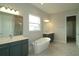 Luxurious bathroom featuring a standalone tub, dual vanities, and modern fixtures for a spa-like experience at 14365 Crest Palm Ave, Windermere, FL 34786
