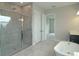 Elegant bathroom featuring a glass-enclosed shower, standalone tub, and modern fixtures for ultimate relaxation at 14365 Crest Palm Ave, Windermere, FL 34786