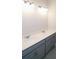 Bathroom features double vanity with gray cabinetry, white countertop, and modern lighting at 14365 Crest Palm Ave, Windermere, FL 34786