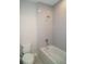 Bright bathroom featuring a tub with shower and a standard toilet at 14365 Crest Palm Ave, Windermere, FL 34786