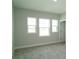 A bedroom features three windows at 14365 Crest Palm Ave, Windermere, FL 34786
