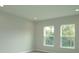 Bright bedroom featuring two windows that provide natural light and offer an outside view at 14365 Crest Palm Ave, Windermere, FL 34786