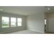 Bedroom featuring three large windows for natural light, neutral walls, and carpeted floor at 14365 Crest Palm Ave, Windermere, FL 34786