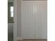 A closet features folding doors, offering convenient storage in a home setting at 14365 Crest Palm Ave, Windermere, FL 34786