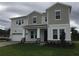 Charming two-story home featuring stone accents and a well-manicured lawn at 14365 Crest Palm Ave, Windermere, FL 34786