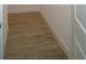 Hallway featuring wood-look floors and white trim, creating a clean and modern look at 14365 Crest Palm Ave, Windermere, FL 34786