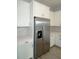 Kitchen featuring stainless steel refrigerator and white cabinets with modern hardware at 14365 Crest Palm Ave, Windermere, FL 34786