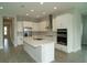 Bright kitchen features a central island, stainless steel appliances, and sleek white cabinetry at 14365 Crest Palm Ave, Windermere, FL 34786