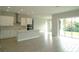 Bright, open kitchen featuring white cabinetry, stainless steel appliances, and a large island with bar seating at 14365 Crest Palm Ave, Windermere, FL 34786