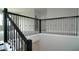 Stairway showcasing a dark metal railing, leading to the upper level, with carpeted steps at 14365 Crest Palm Ave, Windermere, FL 34786