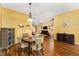 Open dining area with hardwood floors and stylish lighting, connected to the living spaces at 1555 Ward Ct, The Villages, FL 32162