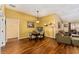 Open-concept dining area with hardwood floors, stylish lighting, and access to the living room at 1555 Ward Ct, The Villages, FL 32162