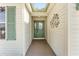 Inviting entryway with a stylish front door, transom window and decorative wall art at 1555 Ward Ct, The Villages, FL 32162