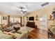 Comfortable living room featuring hardwood floors, a ceiling fan, and sliding doors to the patio at 1555 Ward Ct, The Villages, FL 32162
