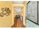 View from entry into a spacious living room with hardwood floors and neutral wall color at 1555 Ward Ct, The Villages, FL 32162