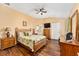 The main bedroom features hardwood floors, ceiling fan and ensuite bathroom at 1555 Ward Ct, The Villages, FL 32162