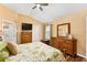 The main bedroom boasts wood floors, a ceiling fan, and ample dresser space at 1555 Ward Ct, The Villages, FL 32162