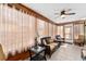 Charming sunroom features wicker furniture, tile floors and lots of natural light at 1555 Ward Ct, The Villages, FL 32162