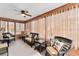 Bright and airy sunroom with wicker furniture, large windows, and tile flooring at 1555 Ward Ct, The Villages, FL 32162