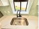 Modern kitchen sink with garden view and beautiful countertops at 1611 Canal Ct, Tavares, FL 32778